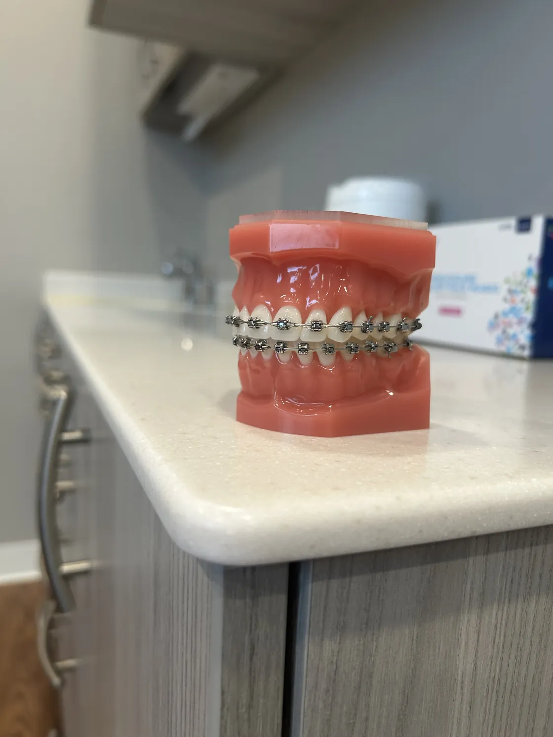 Dental model fitted with braces on a counter in the Sytek Ortho office.